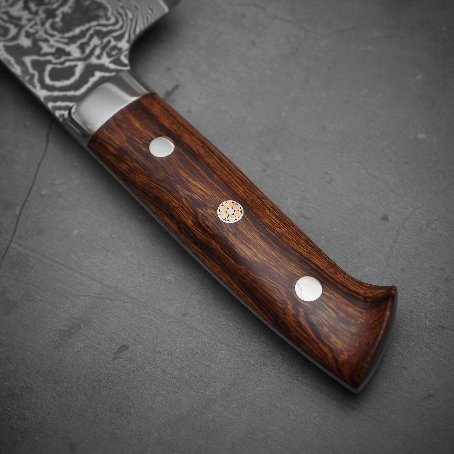Close up view of the handle of Takeshi Saji black damascus SG2 nakiri ironwood