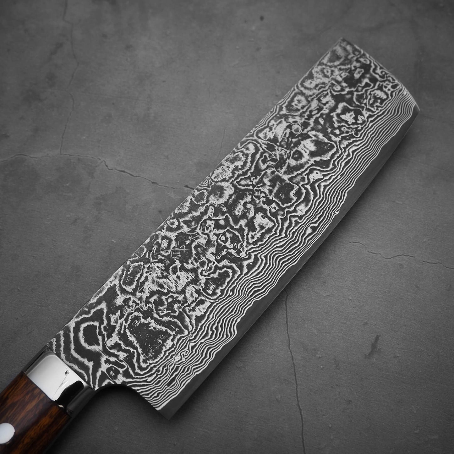 Top view of Takeshi Saji black damascus SG2 nakiri ironwood. Image shows the right side of the knife