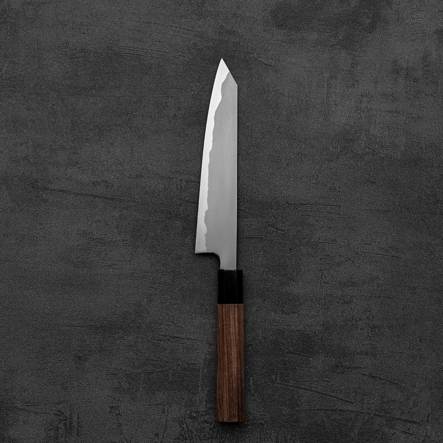 The Tetsujin kasumi aogami#2 petty knife 165mm by Tetsujin features a kasumi finish and wooden handle, with a sharp blade made from premium aogami#2 steel, resting on a dark textured surface.
