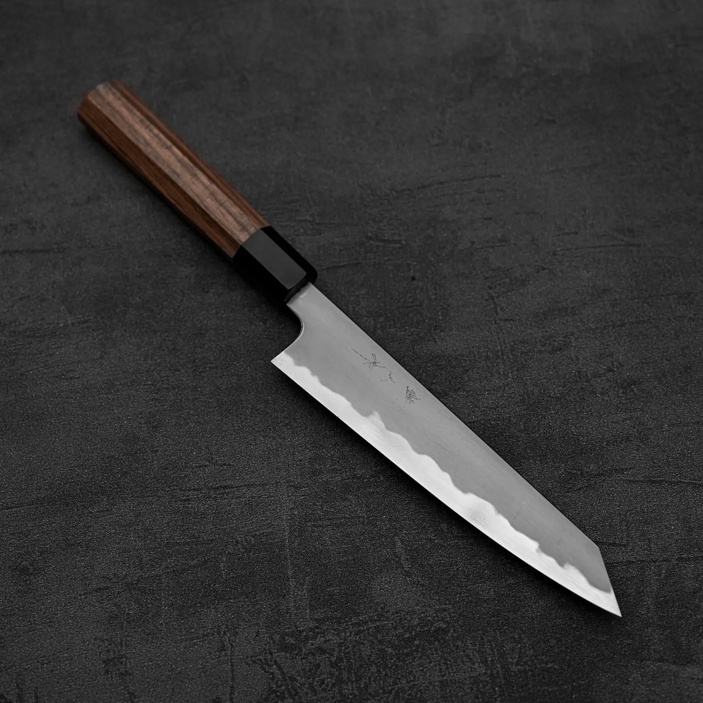 The Tetsujin kasumi aogami#2 petty knife 165mm features a sharp, straight-edged blade and wooden handle with a stunning kasumi finish, elegantly displayed on a dark textured surface.
