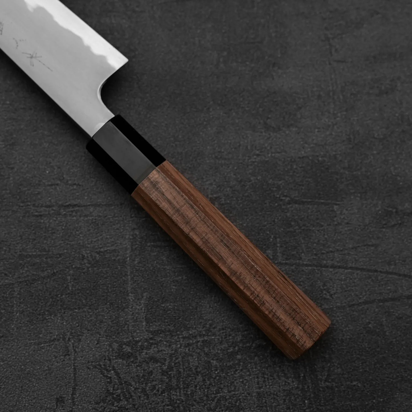 Close-up of the Tetsujin kasumi aogami#2 petty knife 165mm by Tetsujin, featuring a shiny Aogami#2 steel blade and wooden handle, displayed on a dark textured surface.