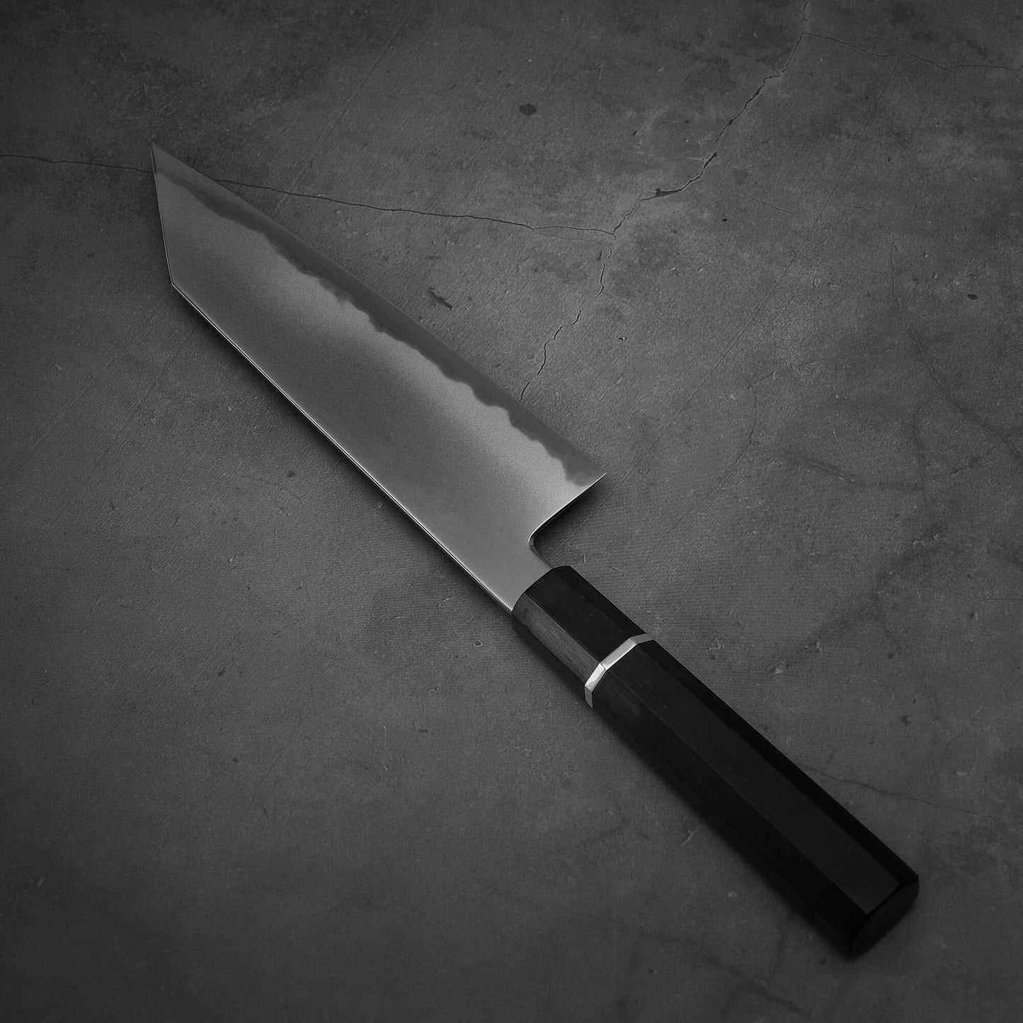 Angled view of Yoshikazu Tanaka AS bunka. This hand-forged Japanese knife is made of aogami super steel.