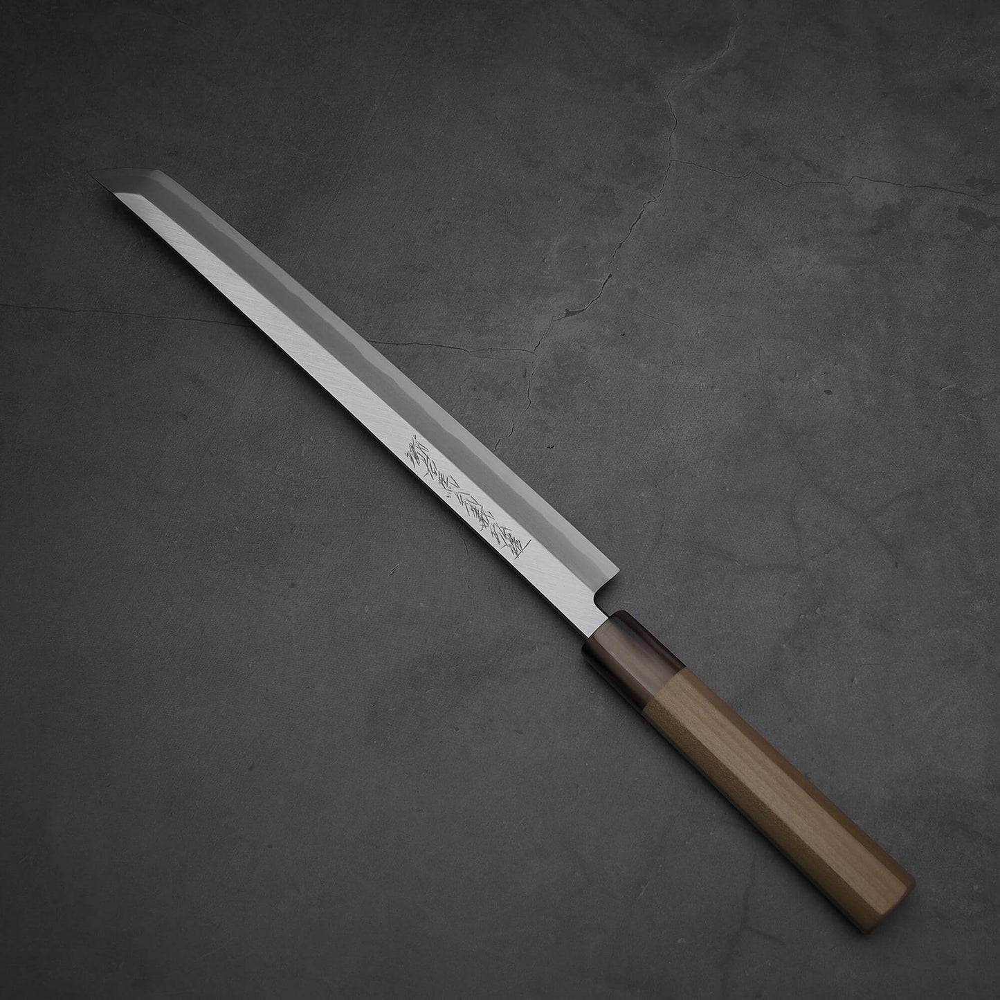 Top-down view of Yoshikazu Tanaka sakimaru takohiki knife with a hand-forged blade made of shirogami#2 steel.