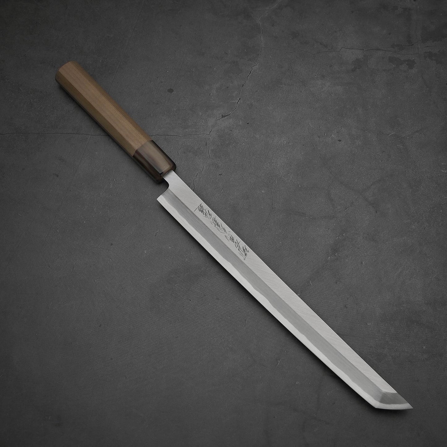 Top-down view of Yoshikazu Tanaka sakimaru takohiki knife with a hand-forged blade made of shirogami#2 steel.