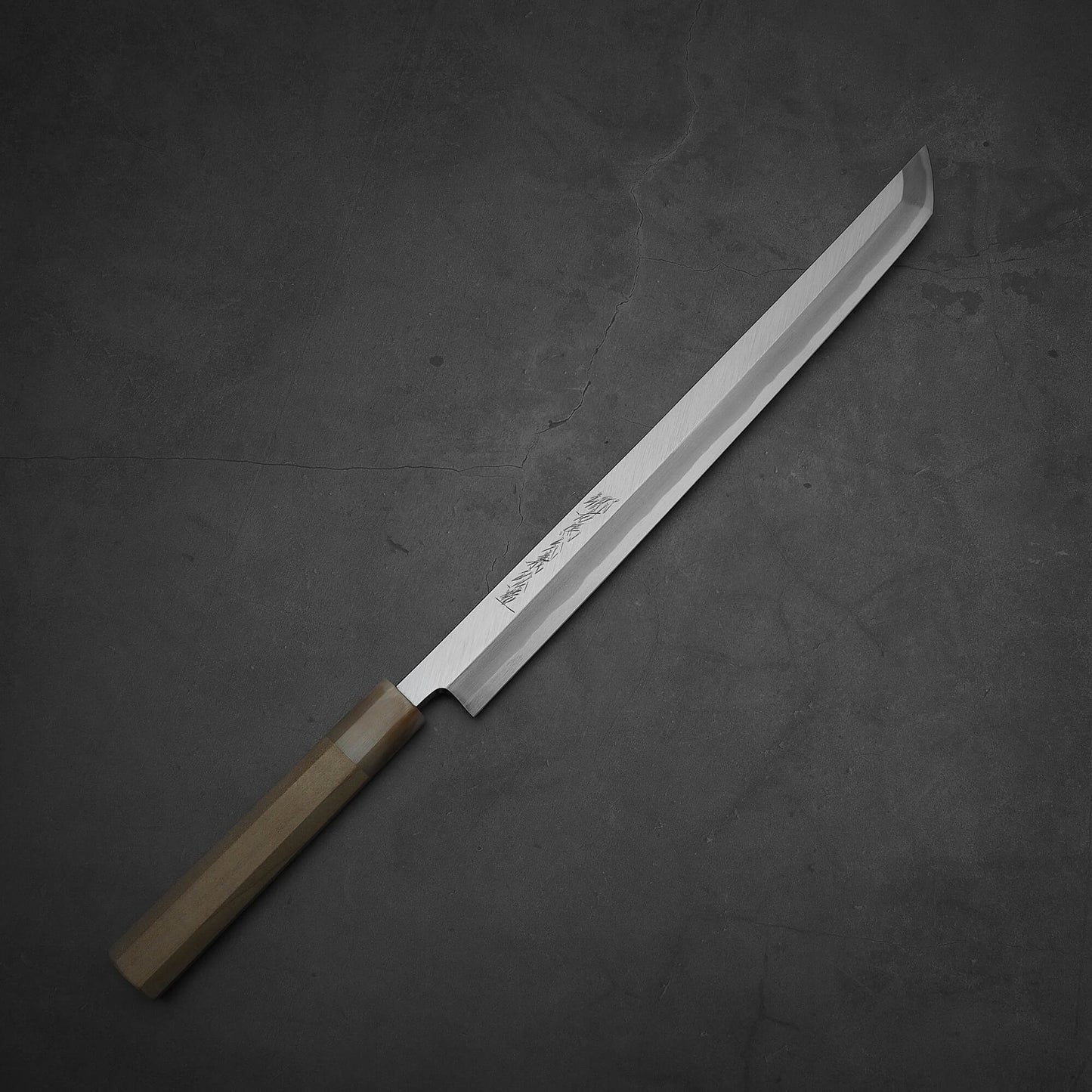 Top down view of Yoshikazu Tanaka 300mm sakimaru takohiki knife with a hand-forged blade made of shirogami#2 steel.