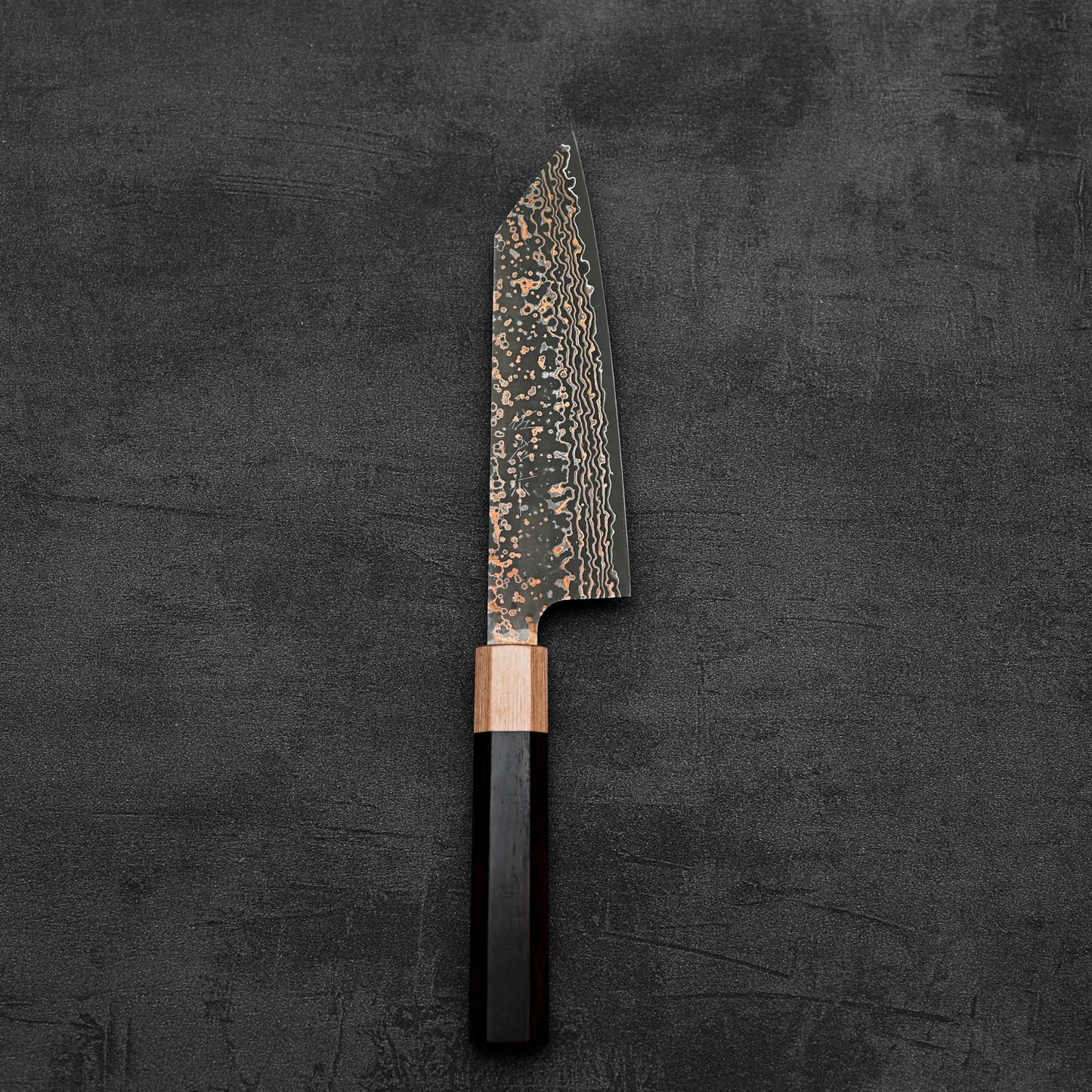 Top down view of Takeshi Saji VG10 Gold damascus bunka knife in vertical position