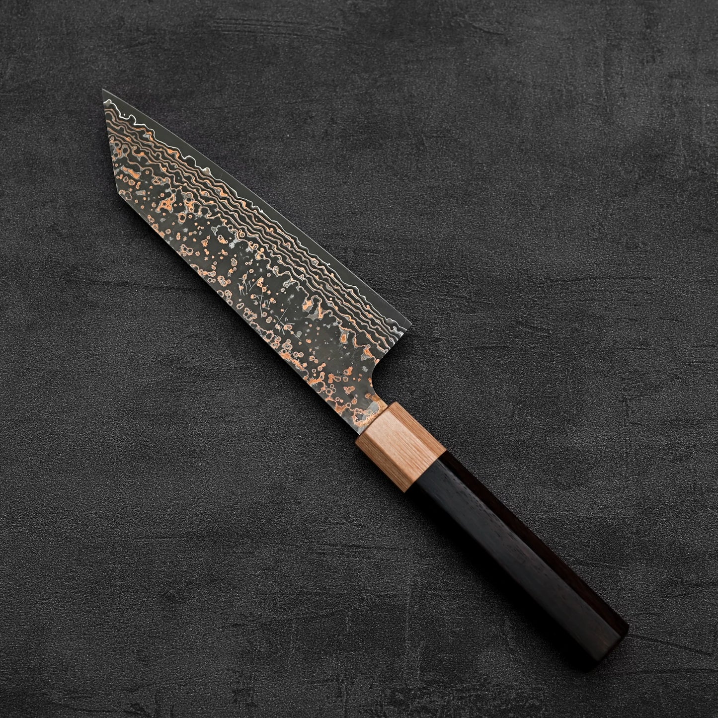Top down view of Takeshi Saji VG10 Gold damascus bunka knife in diagonal position