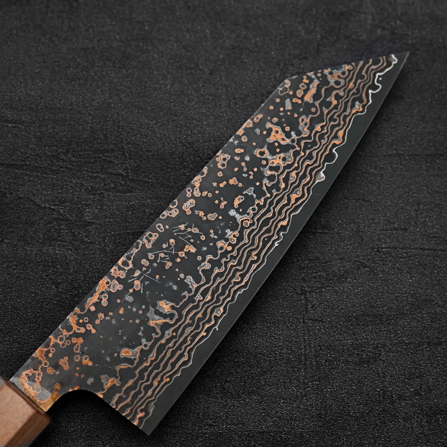 Close up view of the blade of Takeshi Saji VG10 Gold damascus bunka knife