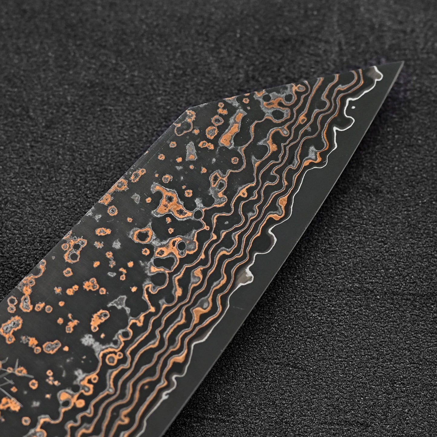 Close up view of the tip of Takeshi Saji VG10 Gold damascus bunka knife