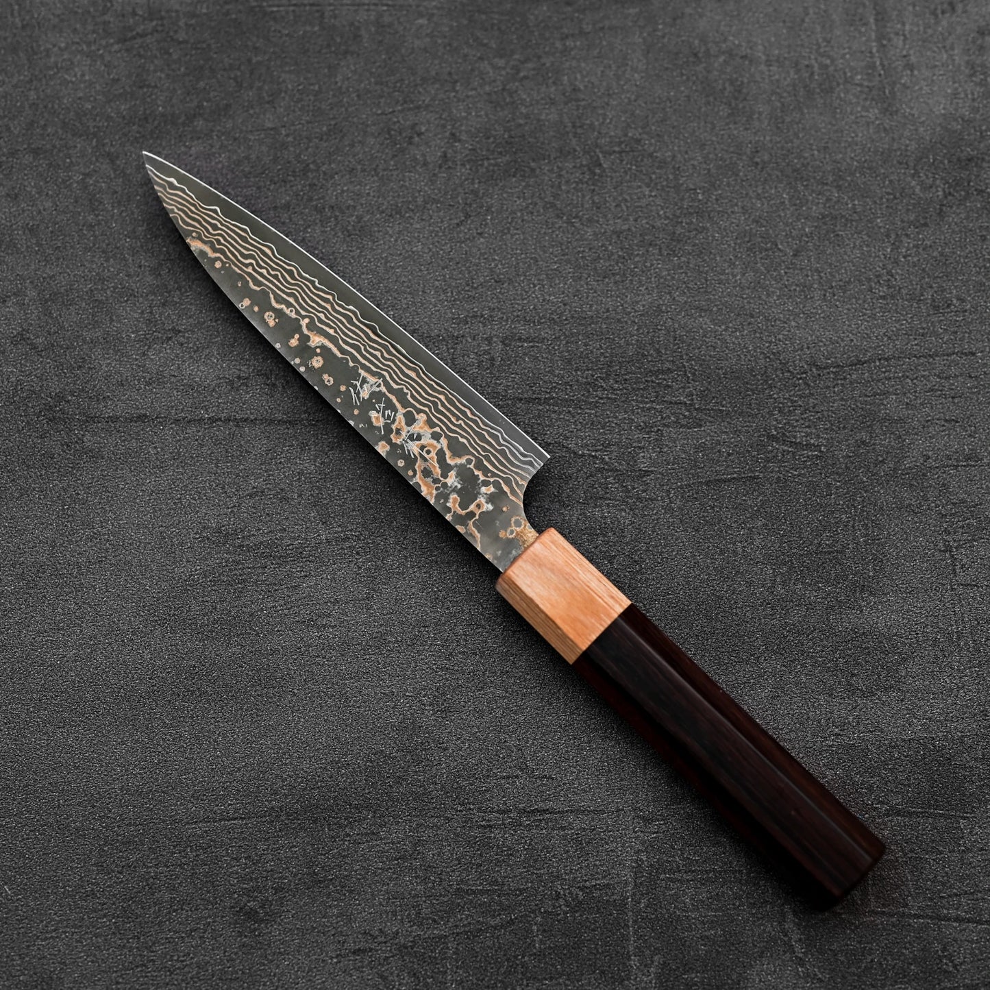 Top down view of Takeshi Saji VG10 Gold damascus petty knife in diagonal position