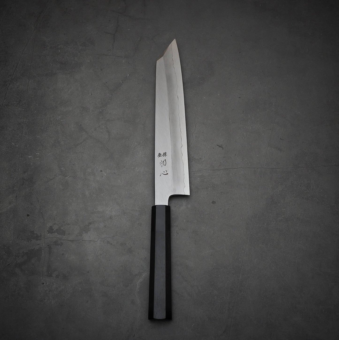 Top view of Hatsukokoro Nakagawa ginsan kiritsuke gyuto knife in vertical position
