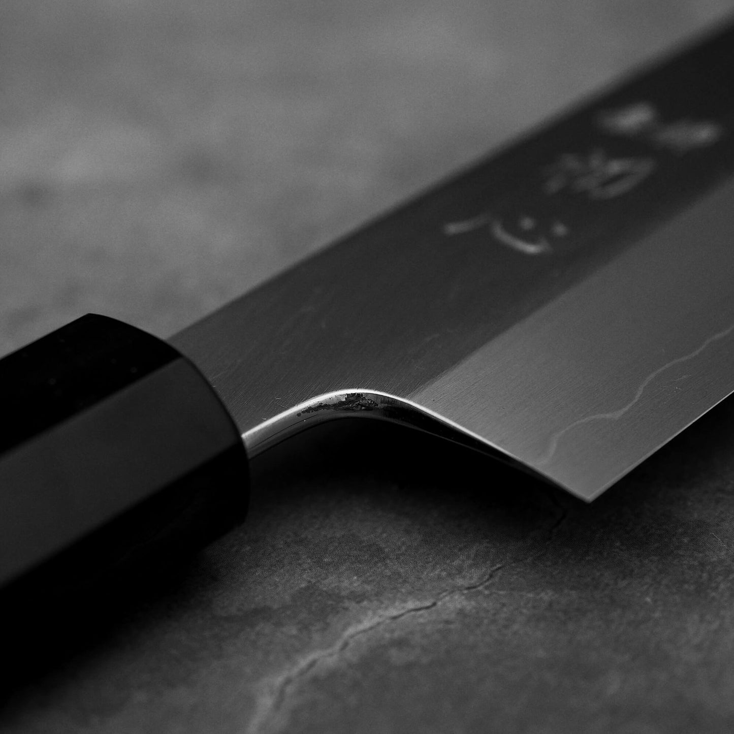 Close up view of the polished choil of Hatsukokoro Nakagawa ginsan kiritsuke gyuto knife