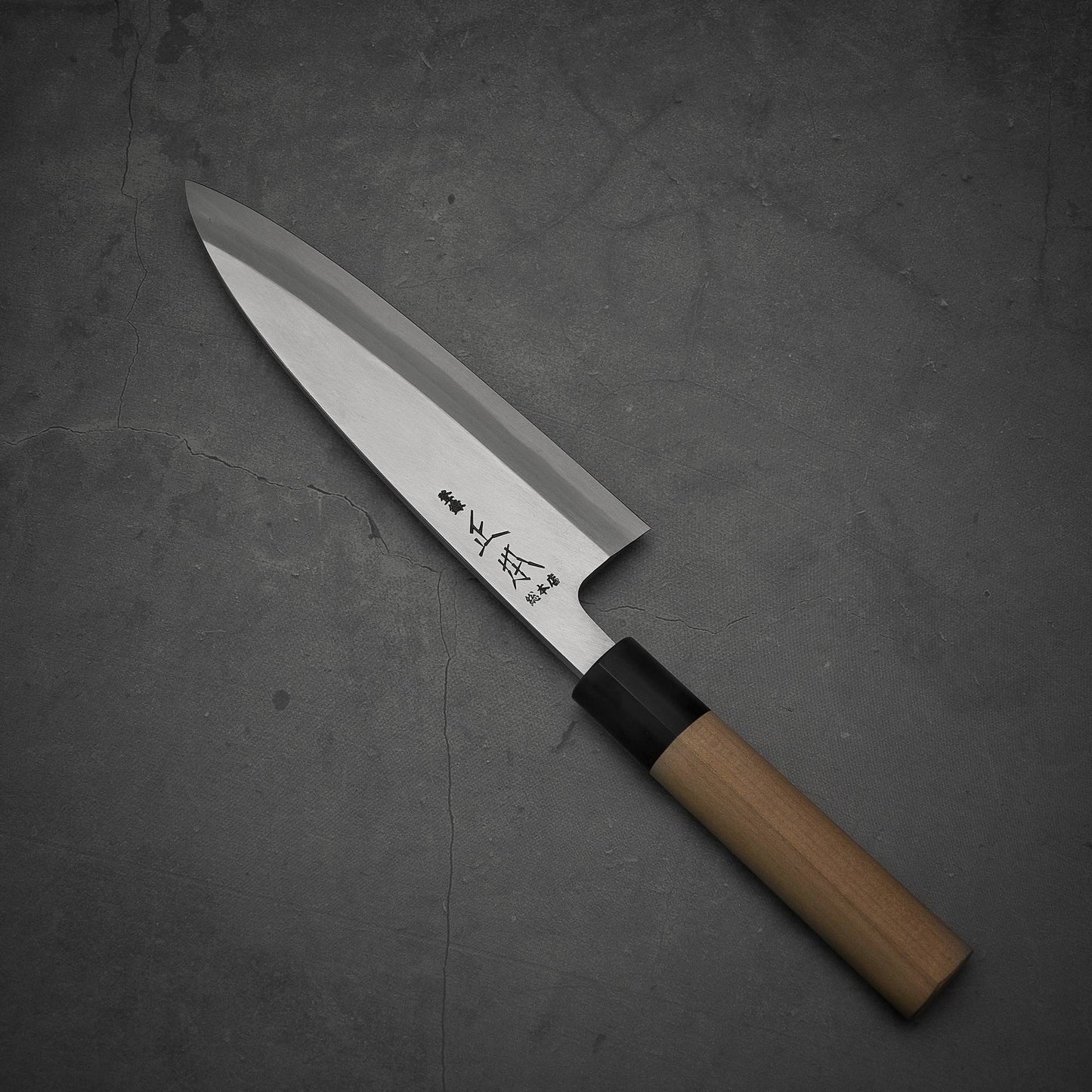 Top view of Masamoto KS shirogami#2 ai-deba knife where pointed tip is facing towards upper left