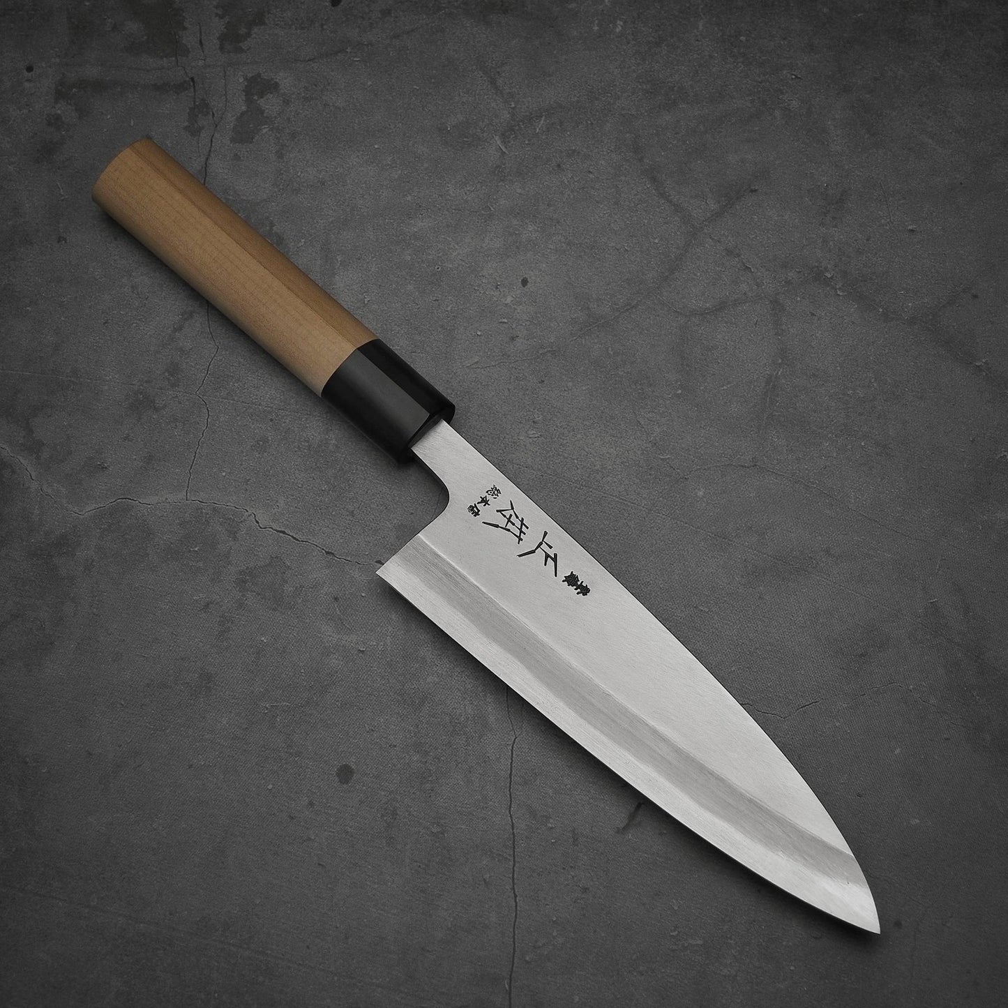 Top view of Masamoto KS shirogami#2 ai-deba knife where pointed tip is facing towards lower right
