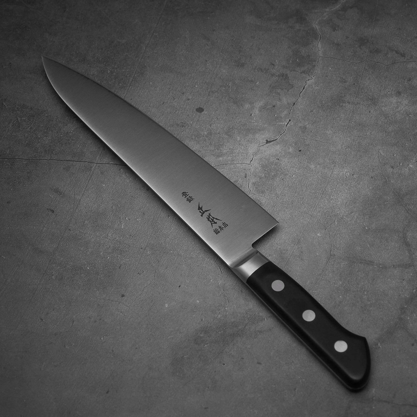 Top view of Masamoto VG yo-gyuto knife. Pointed tip is facing towards the upper left