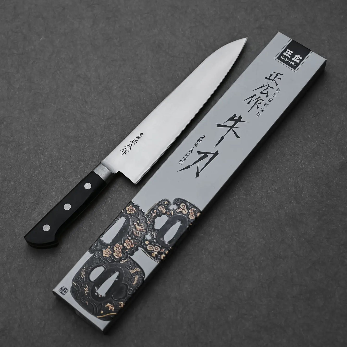 Complete blade profile of the Masahiro carbon chef's knife with its box