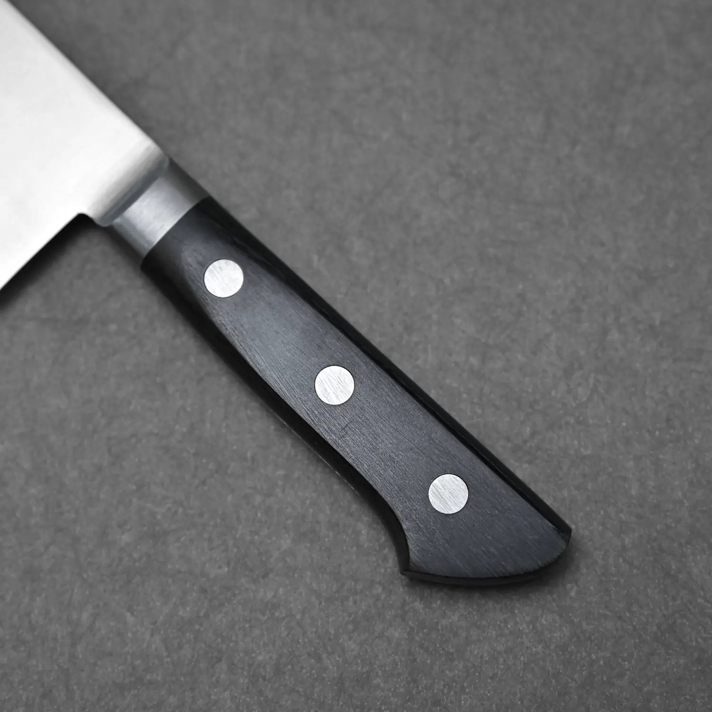 Close-up shot of the reinforced wood handle on the vegetable knife from Masahiro