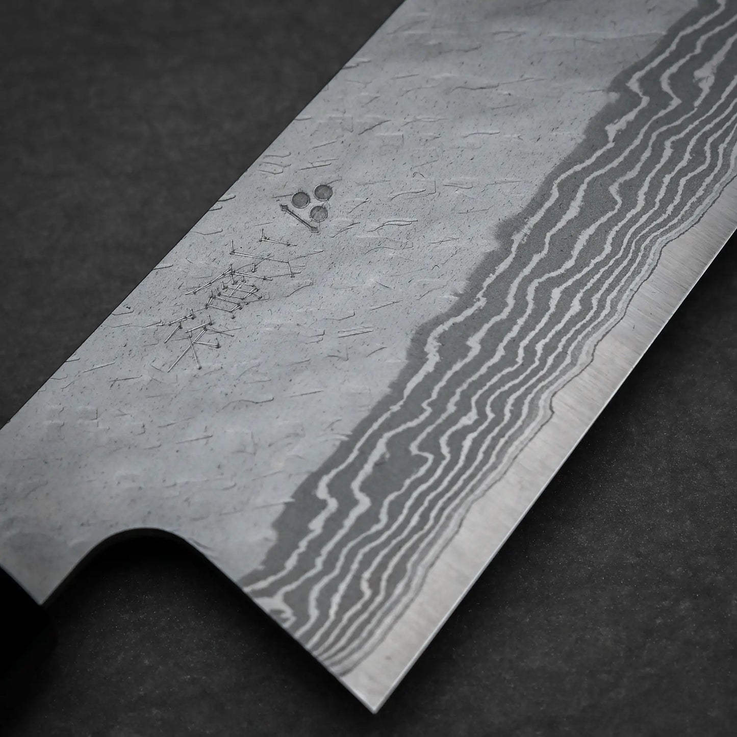 Close up view of the 240mm Nigara tsuchime damascus VG10 gyuto knife right side view showing tsuchime finish