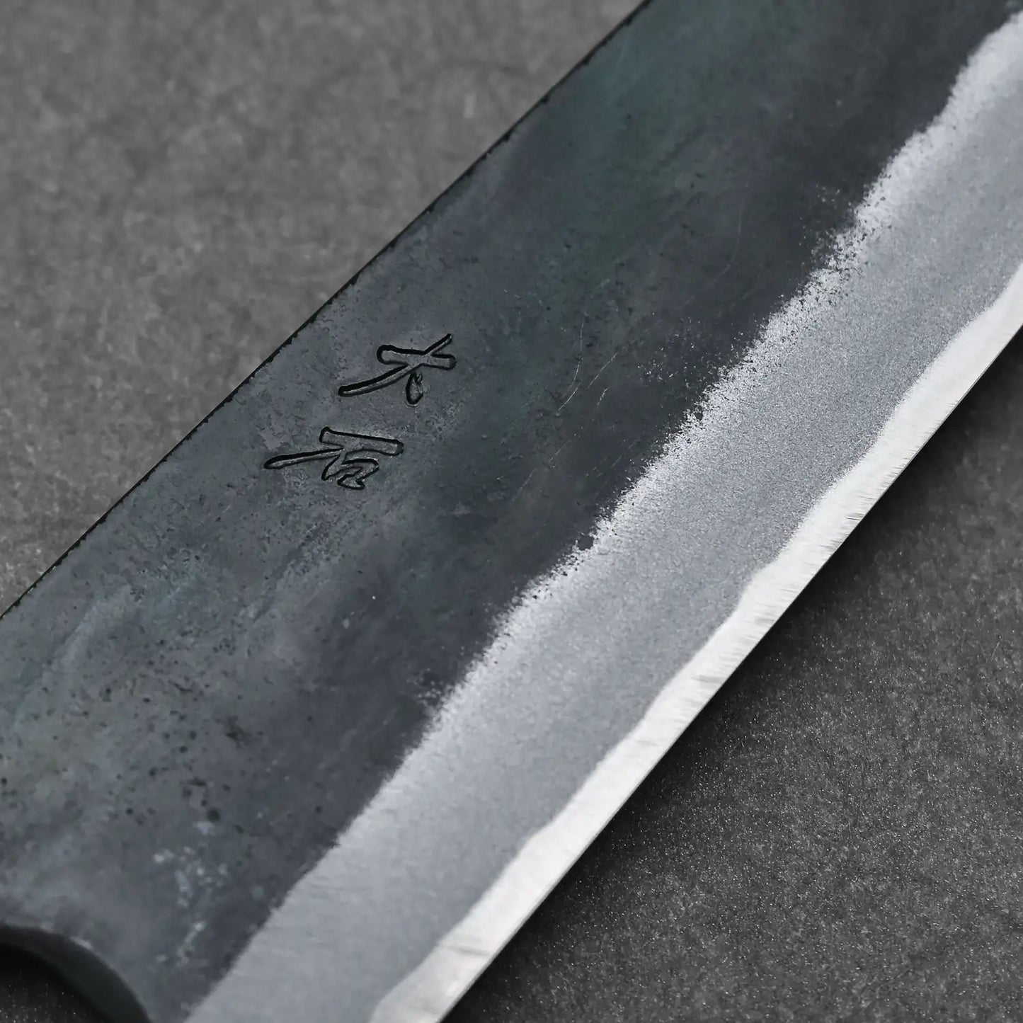 Macro shot of the maker's mark on the Ohishi blue#1 kitchen knife
