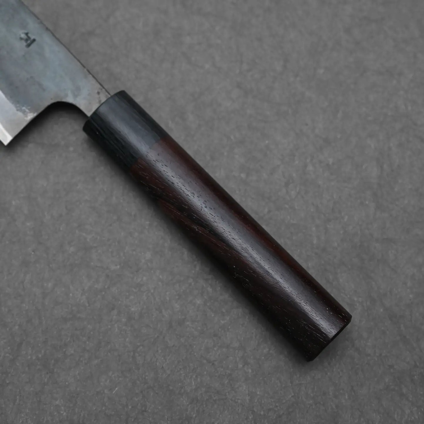 Close-up shot of the rosewood handle of the Ohishi blue#1 Japanese chef's knife