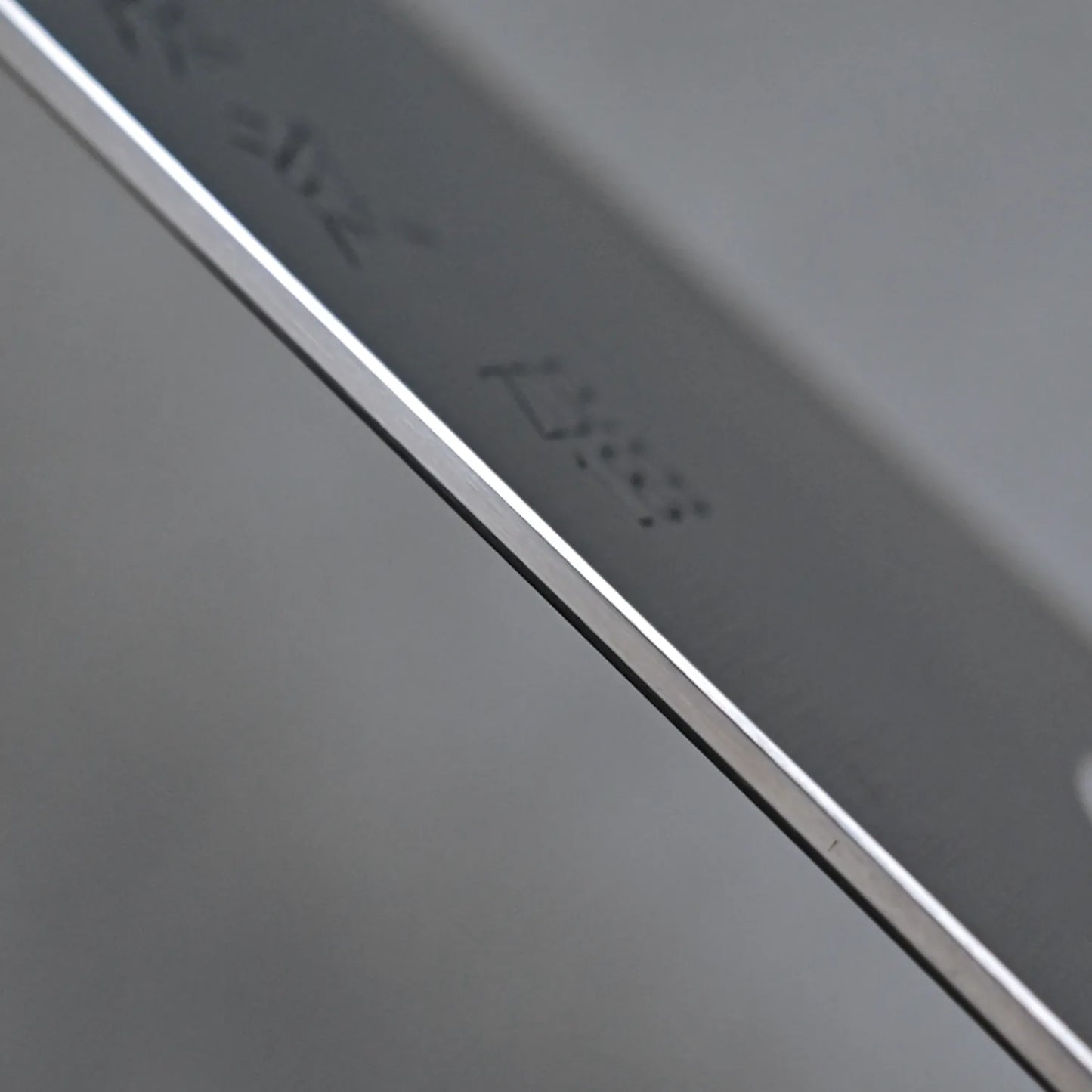 Close-up of the Sukenari ZDP189 kiritsuke gyuto 270mm blade, crafted from premium stainless steel with etched markings, set against a plain gray background.