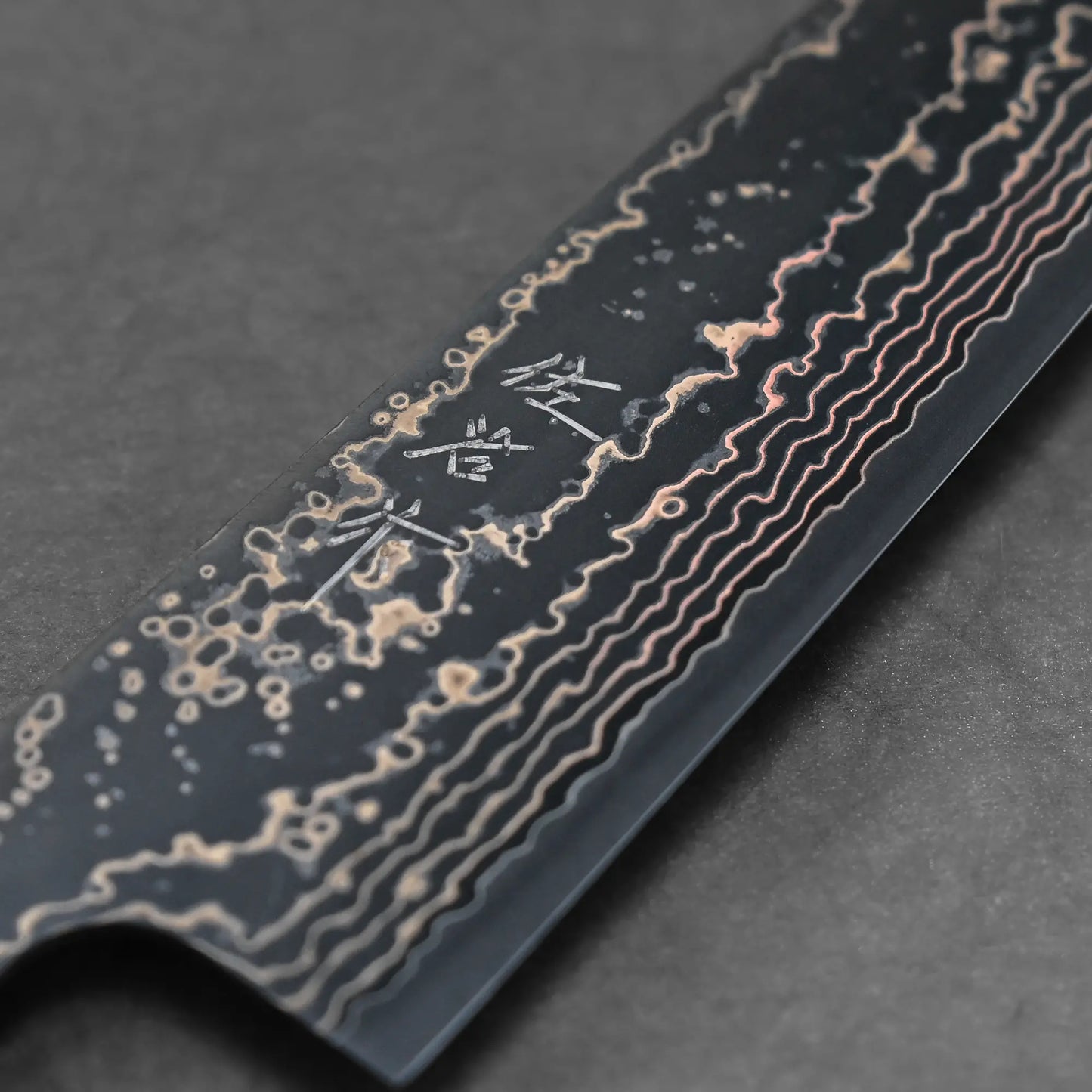 Close-up shot of the maker's mark on 210mm Takeshi Saji knife VG10 Gold damascus gyuto