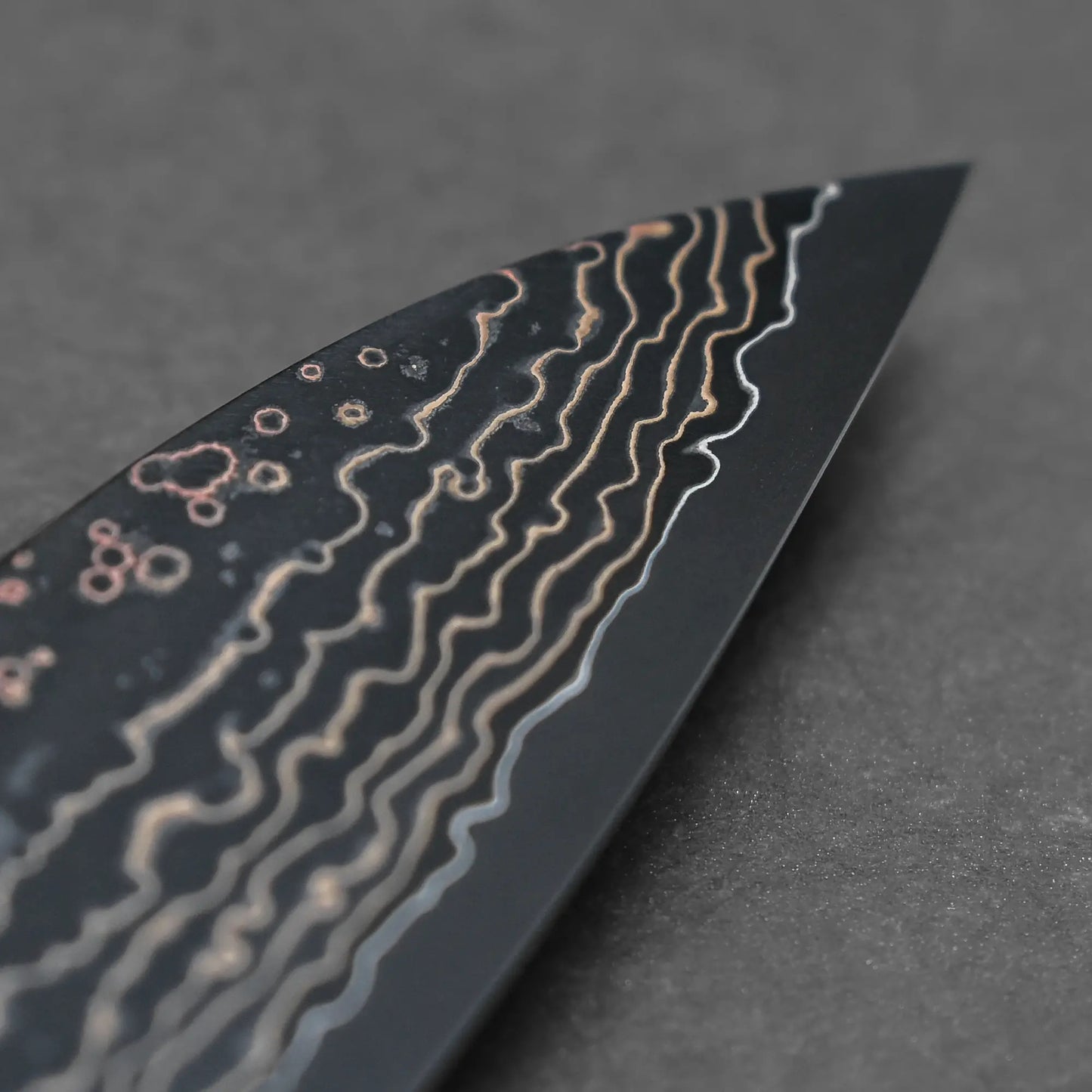 Close-up shot of the tip area of 210mm Takeshi Saji knife VG10 Gold damascus gyuto main side view