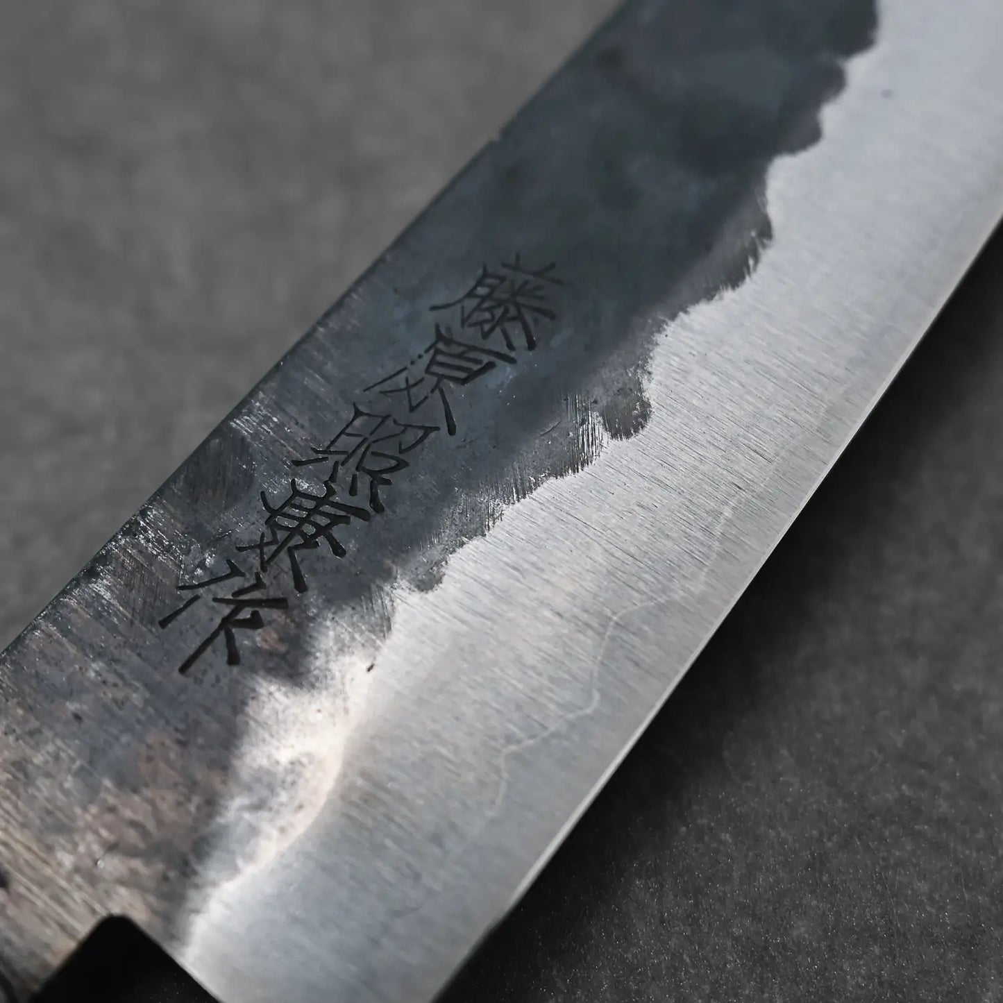 Macro shot of the maker's mark on the 120mm denka petty