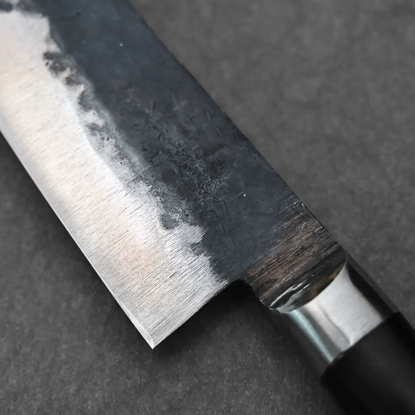 Macro shot of the back side of the blade of the 120mm denka petty