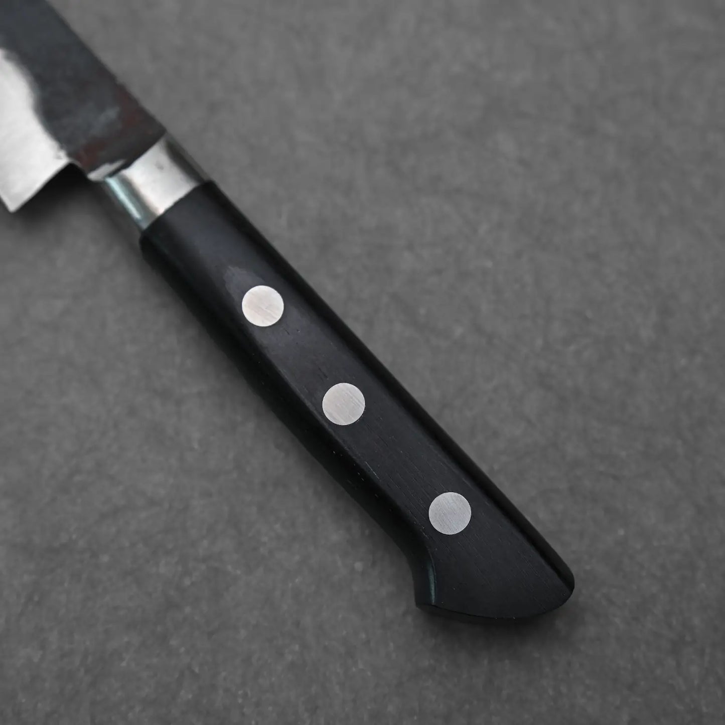 Close-up view of the handle of denka petty knife