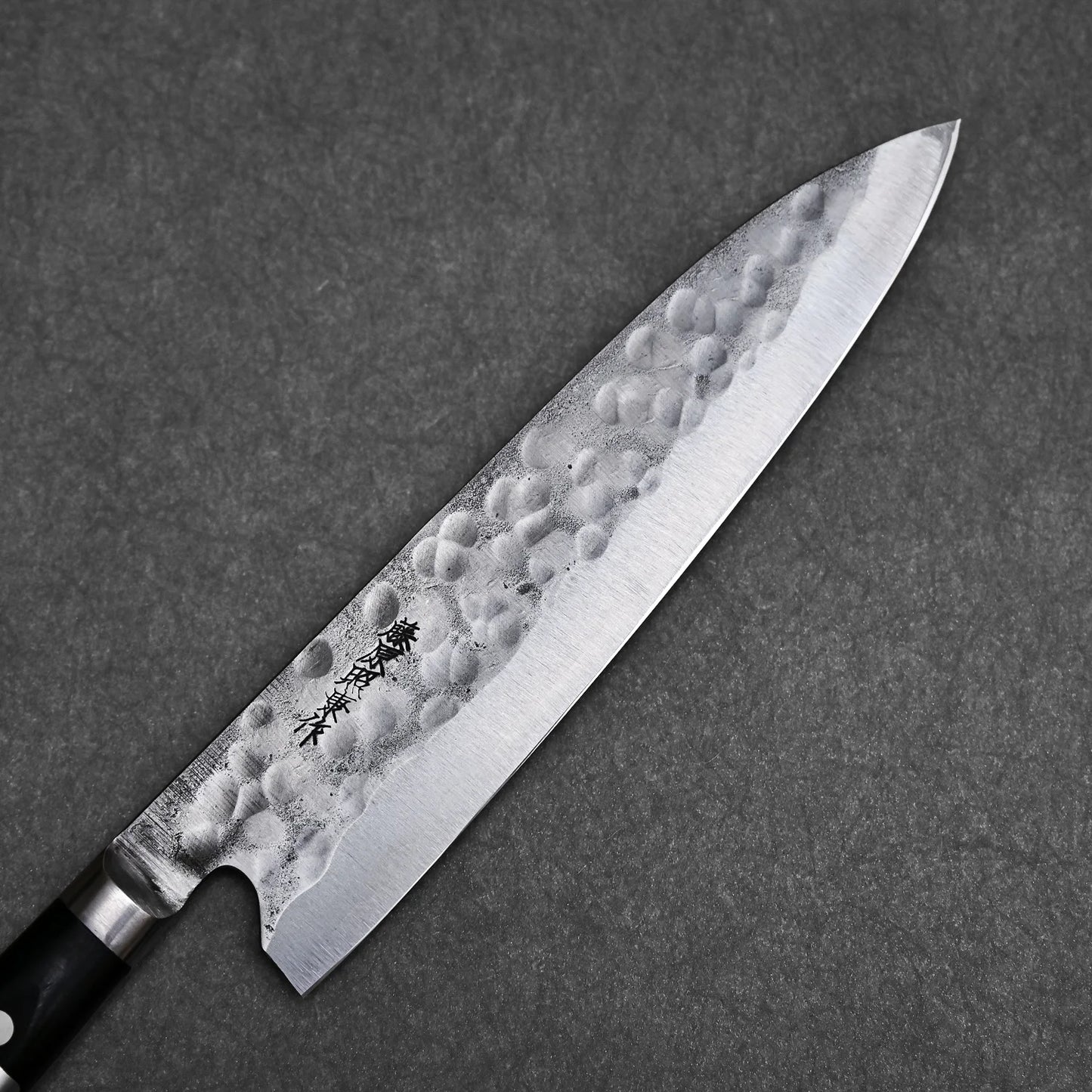 Close-up view of the blade showing tsuchime finish and maker's mark