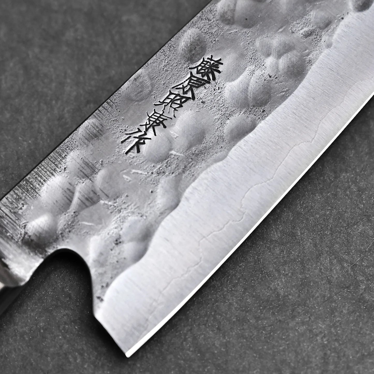 Macro detail of the maker's mark on the Fujiwara gyuto