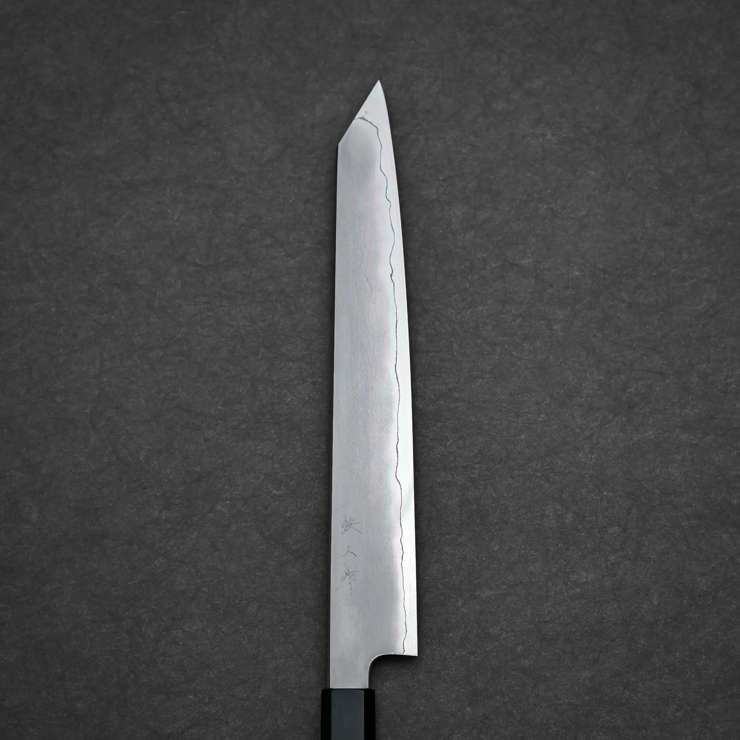 The Tetsujin kasumi ginsan kiritsuke sujihiki 240mm, a single-edged Japanese knife with a straight blade and angled tip, is crafted from Ginsan steel with a visible hamon line, kasumi finish, and subtle engravings near the handle.