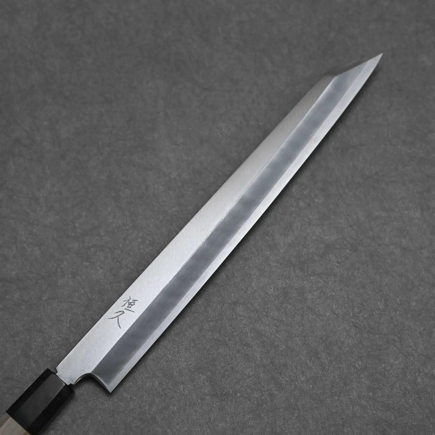 Close-up view of the 270mm ginsan ktip yanagi knife showing the front blade with kanji stamp
