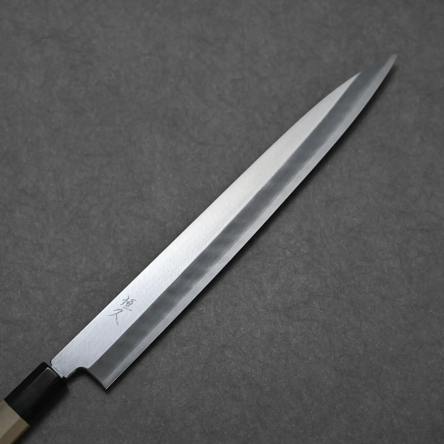 Close-up of Tsunehisa 300mm yanagi showing migaki finish and the kanji