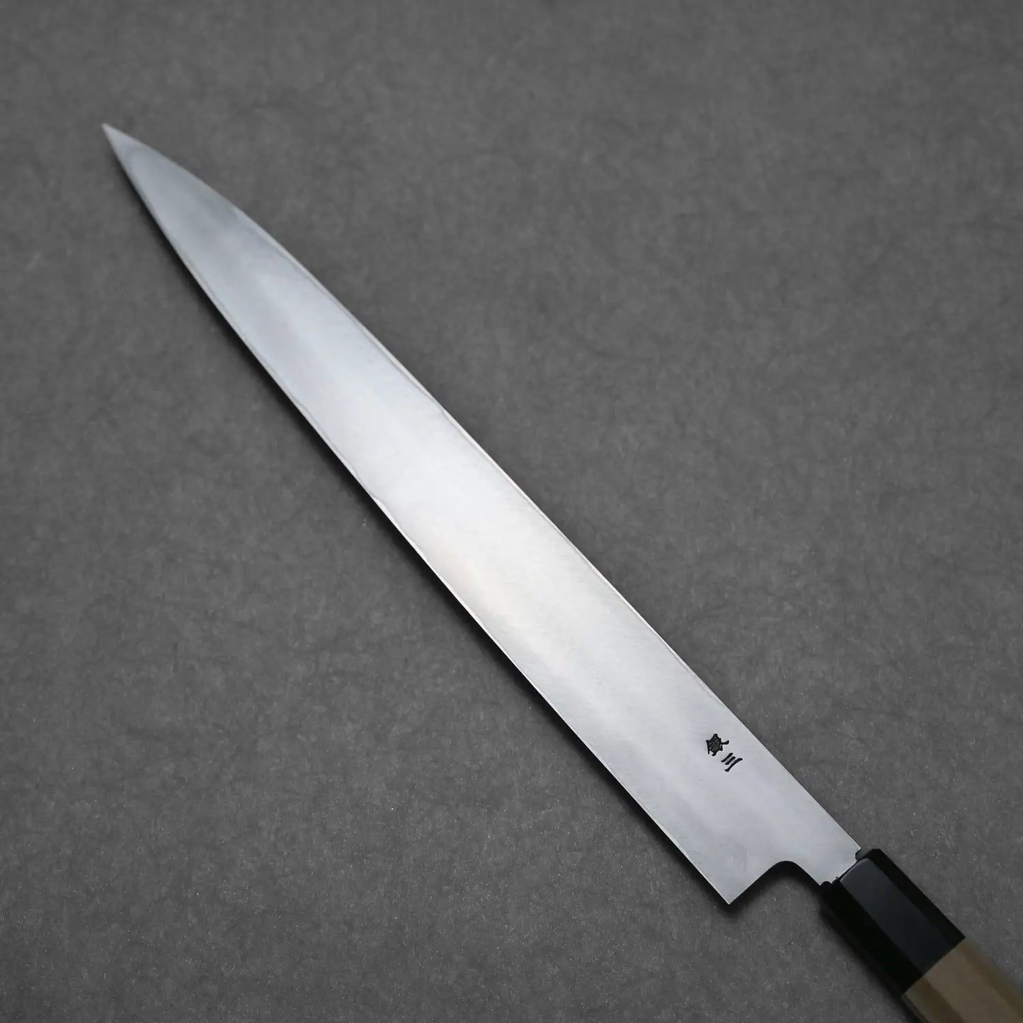 Backs side of the yanagi knife showing urasuki and the ginsan steel stamp