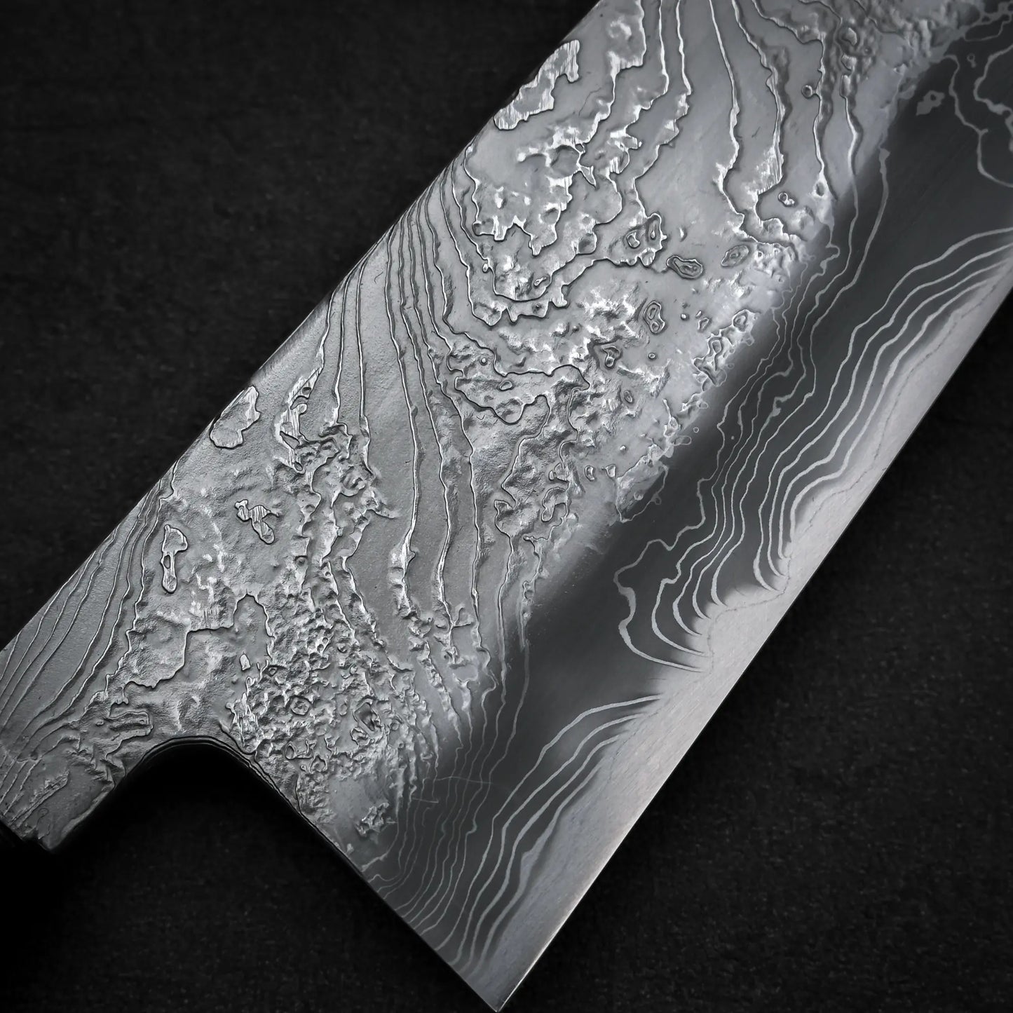 Macro shot of the front balde of Yoshihide Masuda shirogami#2 damascus tall gyuto knife