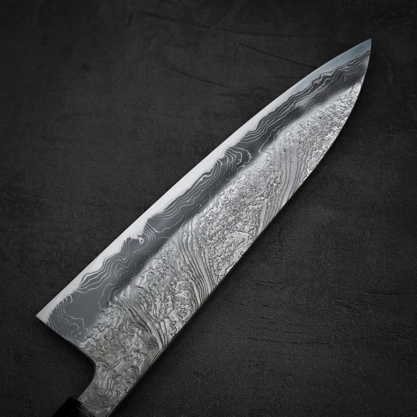 Close up view of the back side of Yoshihide Masuda shirogami#2 damascus tall gyuto knife