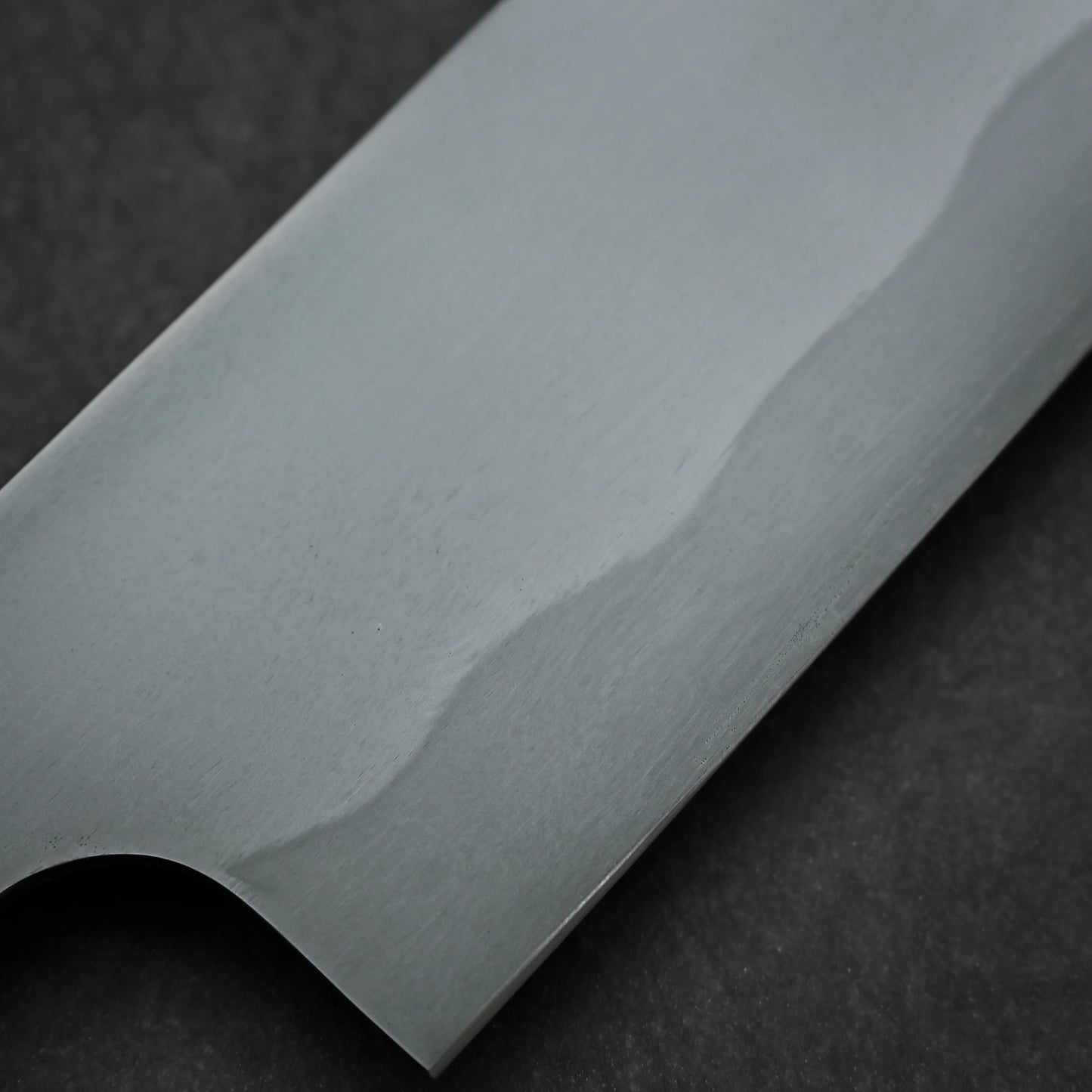 Close-up shot of the blade of 180mm Yoshihiko Akitomo knife aogami#2 honyaki santoku