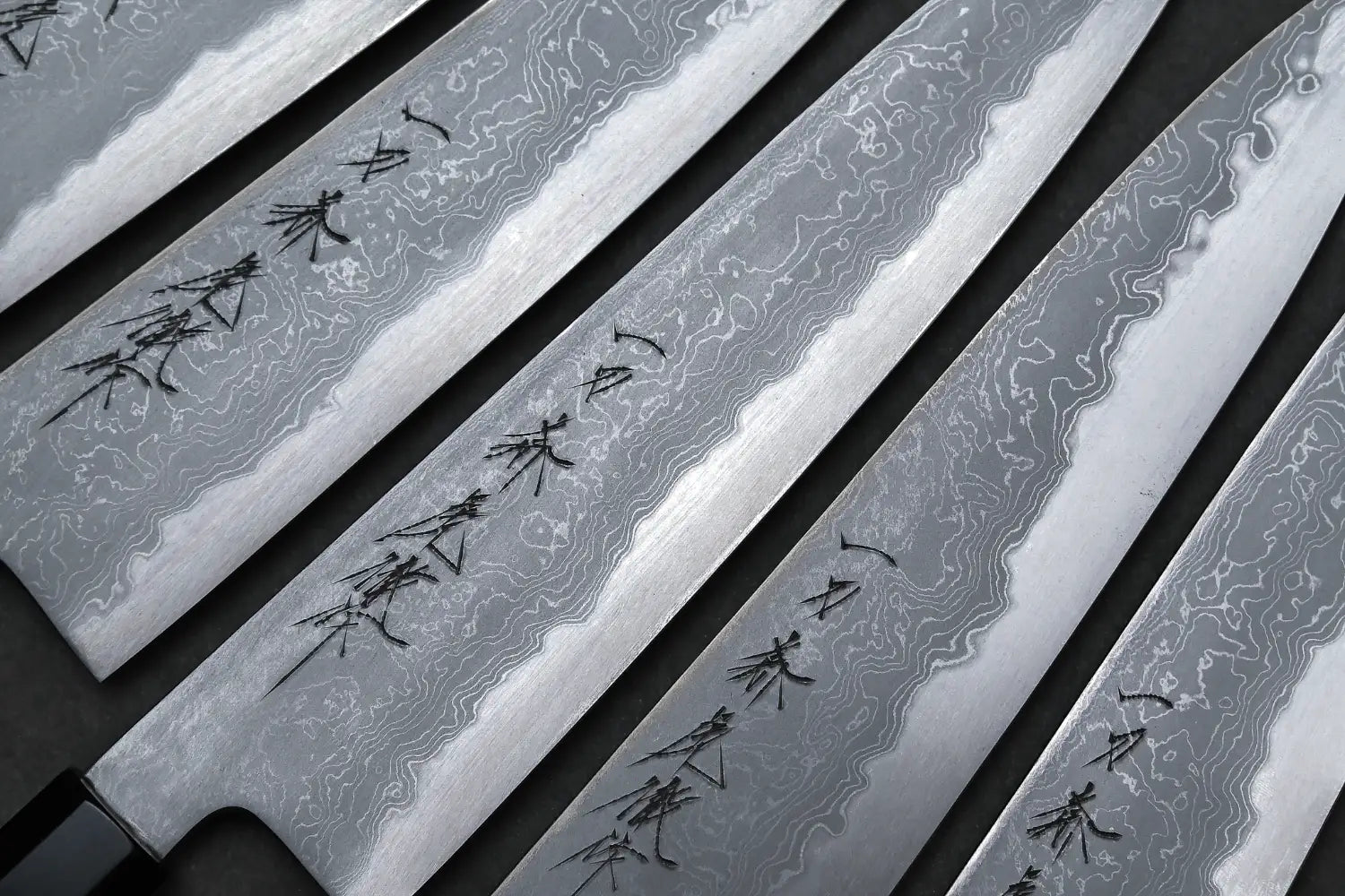 A close up photo of damascus gyuto knives by Yoshikazu Tanaka