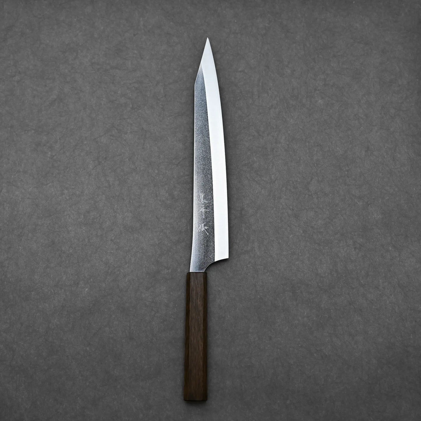 Complete view of the Kurosaki slicing knife in vertical orientation