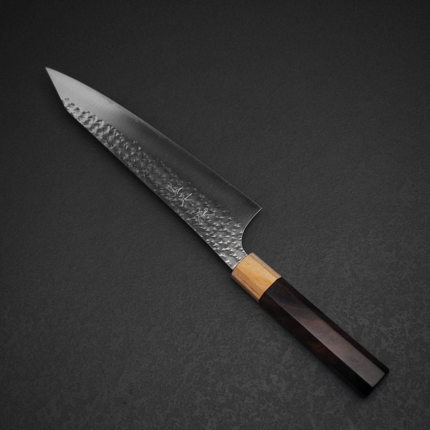 Top view of Yu Kurosaki SG2 Senko kiritsuke gyuto 210mm in diagonal position where tip is facing upper left