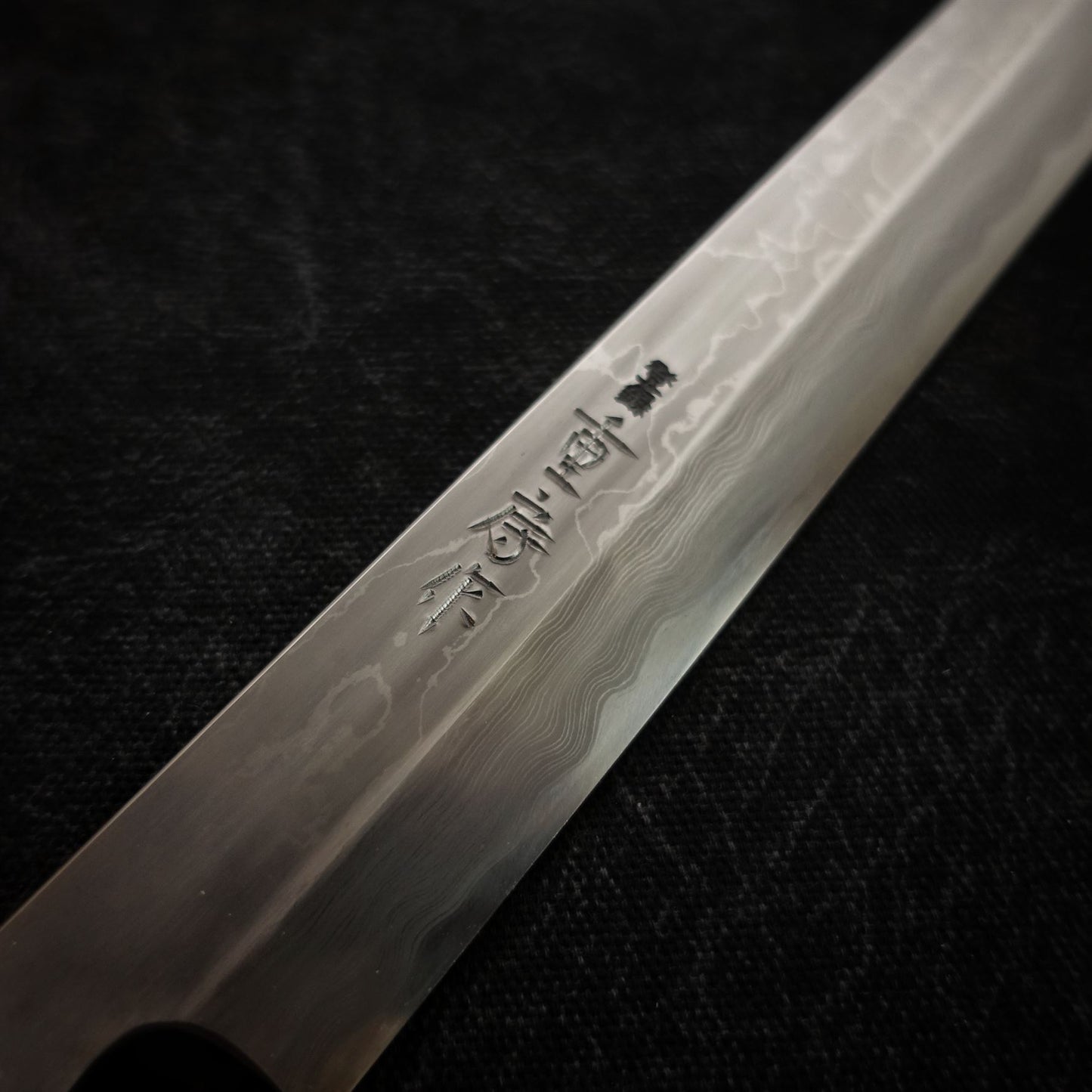 Close-up view of 330mm kitaeji yanagiba Shigefusa knife showing maker's mark