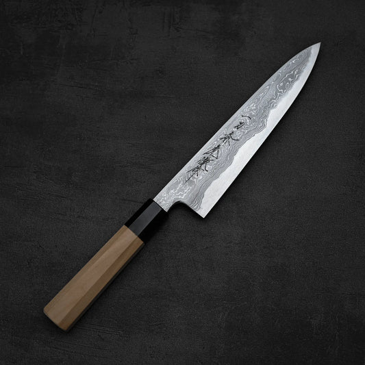 Full profile view of a Yoshikazu Tanaka gyuto knife with damascus finish