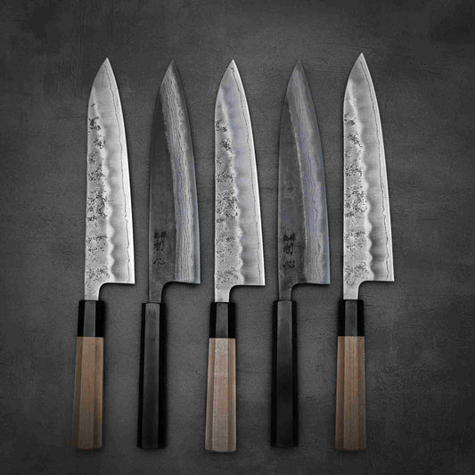 Top down photo of Japanese chef knives from Misono cutlery and Sakai Kikumori