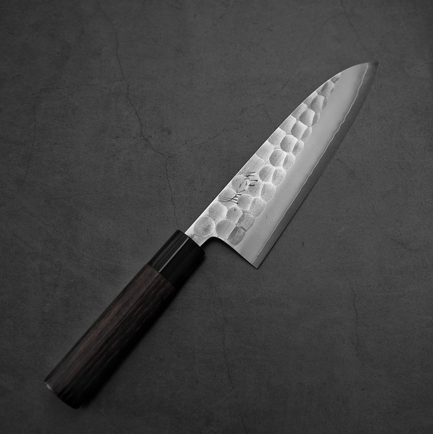 Top down view of a Yoshikane tsuchime SKD santoku knife