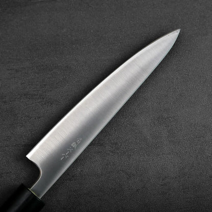 A petty knife with a black handle is shown, highlighting the blade and handle design in close detail.