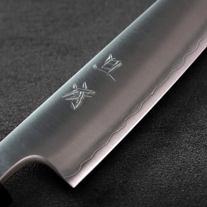 Close-up of a petty knife blade, 135mm, with engraved characters visible.