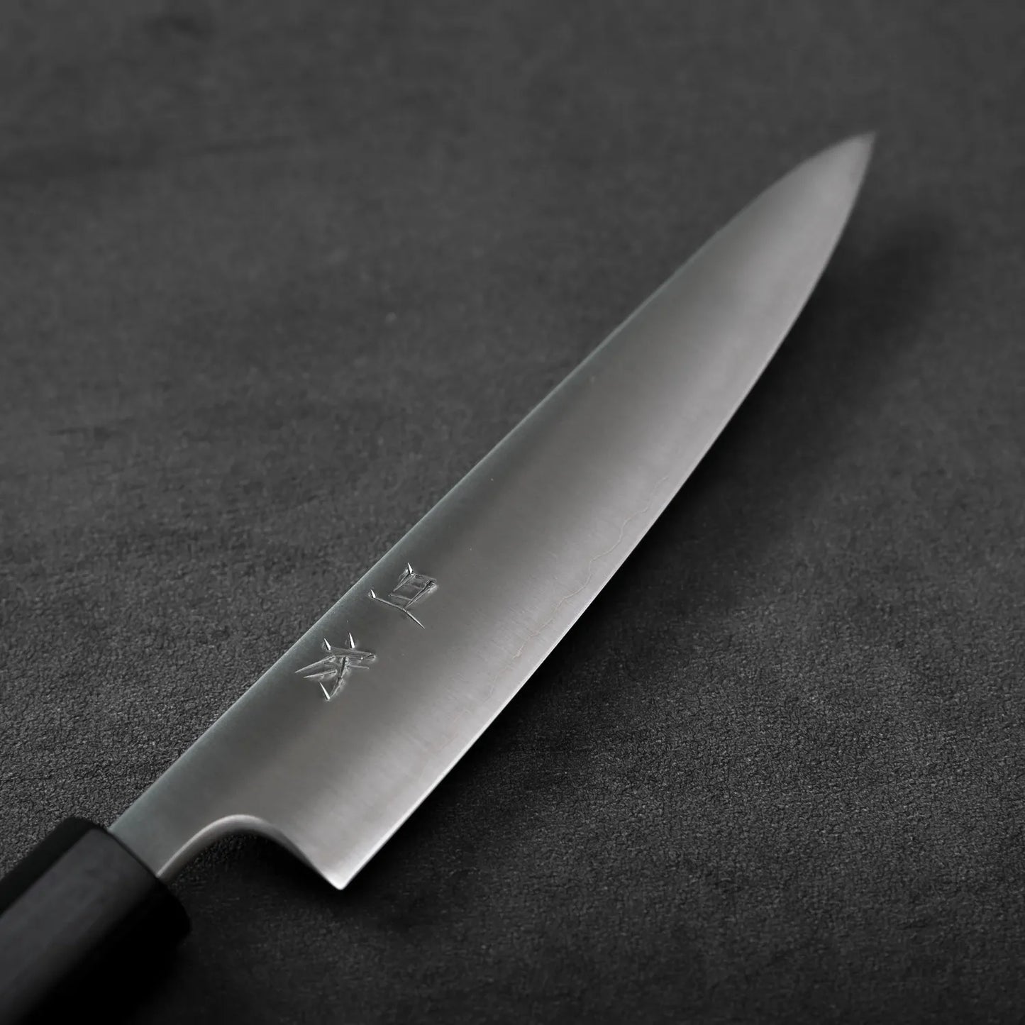 Close-up of a petty knife, showing blade characters in detail.