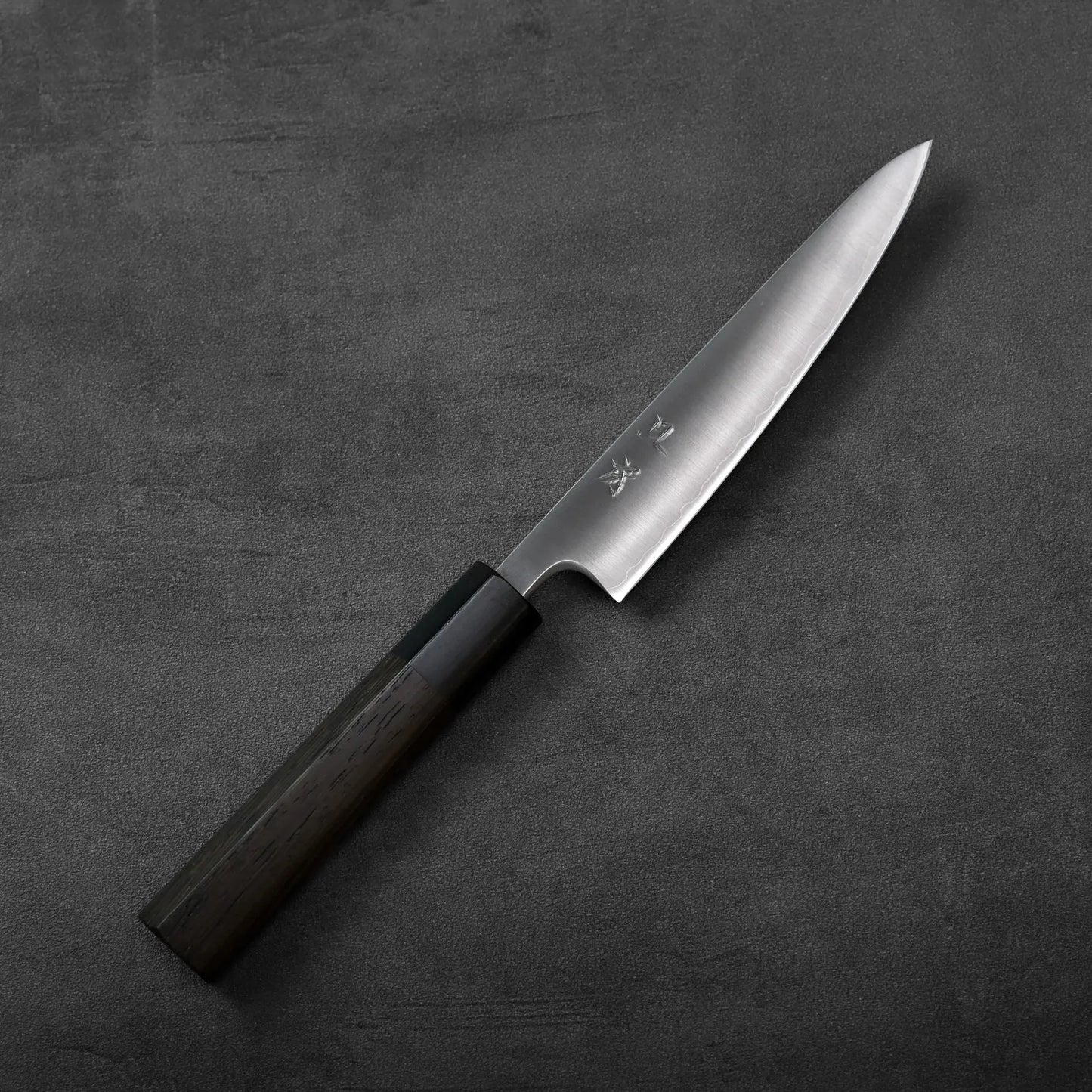 Petty knife with Aogami Super blade positioned to show its compact length and polished finish.